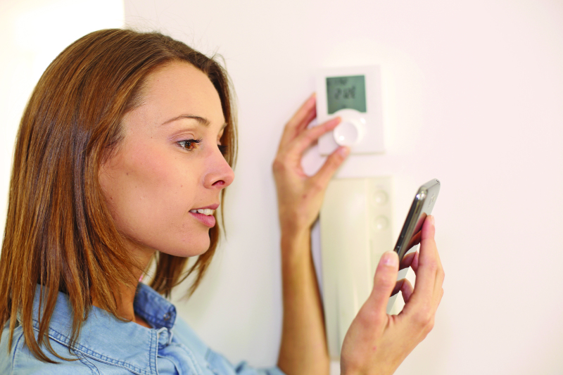 Woman Checking Temperature Air Conditioning