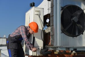 Worker Replacing Air Conditioning
